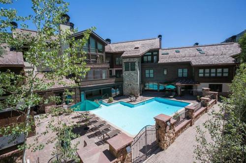 an aerial view of a house with a swimming pool at Northwoods Easy Ski In Ski Out Access in Vail