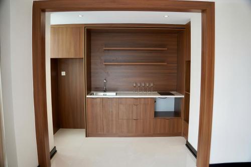 a kitchen with a sink and a wooden wall at Novotel Ha Long Bay Hotel in Ha Long