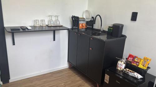 a kitchen with a sink and a counter at Tiny House Socorro in Socorro