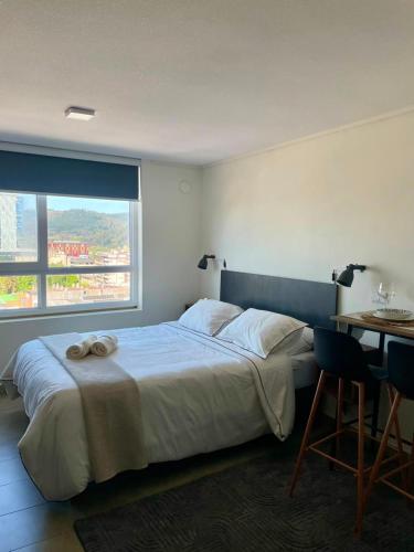 ein Schlafzimmer mit Bett, Schreibtisch und Fenster in der Unterkunft Epic Hotel Temuco in Temuco
