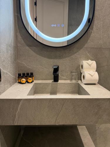 a bathroom with a sink and a mirror at Living Fleuri Suites & Studios in Casablanca