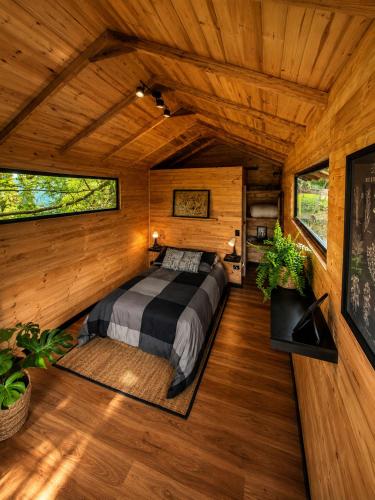 a bedroom in a tree house with a bed in it at Basecamp Colombia in Carmen de Carupa