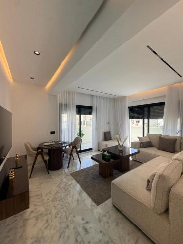 a living room with a couch and a table at Living Fleuri Suites & Studios in Casablanca