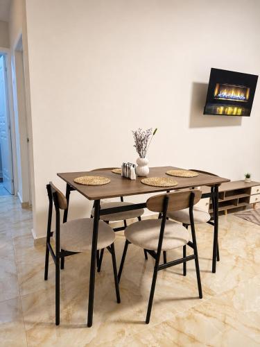 a dining room table with two chairs and a table at Alojamiento en Miches in Miches