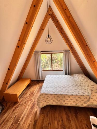 a bedroom with a bed in a attic at La cabaña del jaguar in Tepoztlán