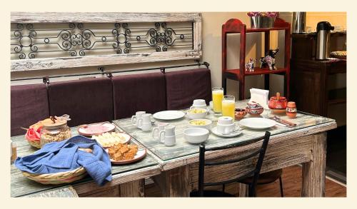 a table with food and drinks on top of it at Wakapunku Boutique B&B in Cusco