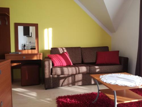 a living room with a couch and a table at Luxury Apartment in Bešeňová