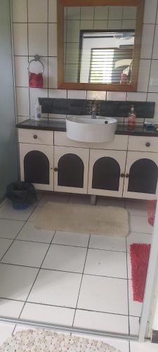 a bathroom with a sink and a mirror at Ali's Homestay in Pacific Harbour