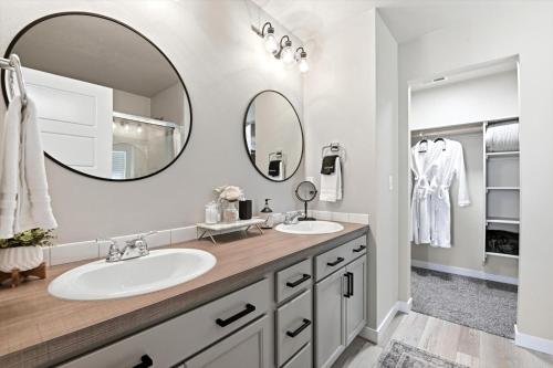 a bathroom with two sinks and a large mirror at Mineral Spa Fire Pit Game Room Mini Split AC in Meridian