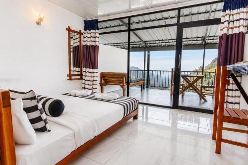 a bedroom with a bed and a view of the ocean at Onestar Ella in Ella