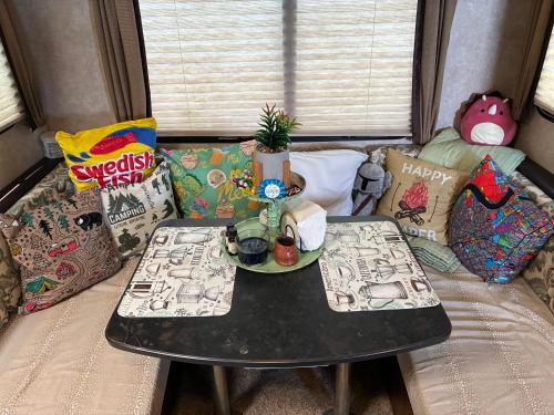 a small table in a room with pillows at My Little RV Getaway in Pass Christian