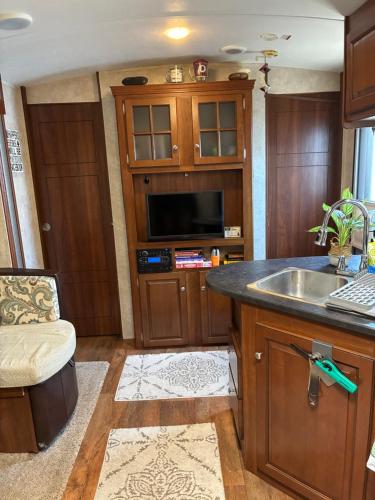 a kitchen with a sink and a microwave at My Little RV Getaway in Pass Christian