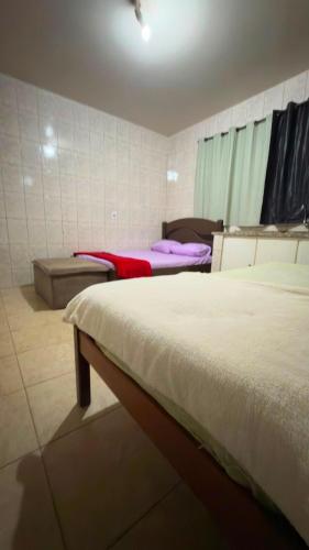 a bedroom with two beds in a room at Pousada Dois Irmão in Uberaba