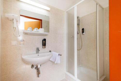 a bathroom with a sink and a shower at Lenas Donau Hotel in Vienna