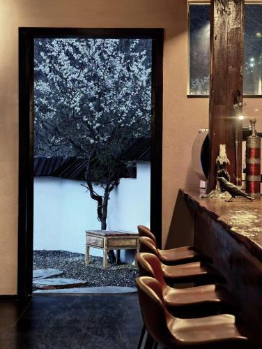 a bar with a window with a tree outside at NINE PEAKS in Jiuzhaigou