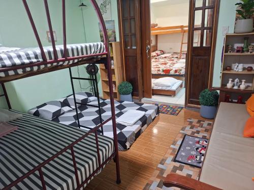 a room with a bunk bed and a living room at Dalinda's Homestay in Puerto Princesa City