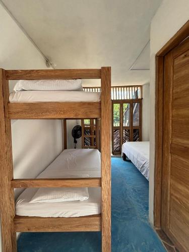 two bunk beds in a room with a doorway at La Casa de la Tortuga in San Onofre