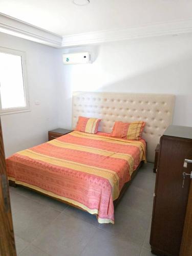 a bedroom with a large bed with two pillows at Bab bhar sousse in Sousse