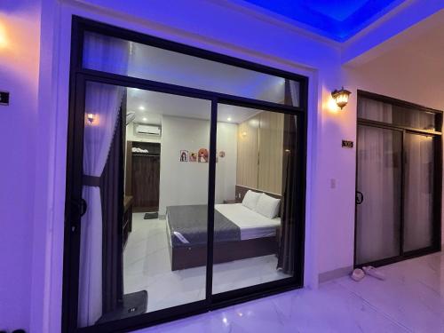 a room with a window with a bed in it at Hải Đảo Homestay in Quan Lạn