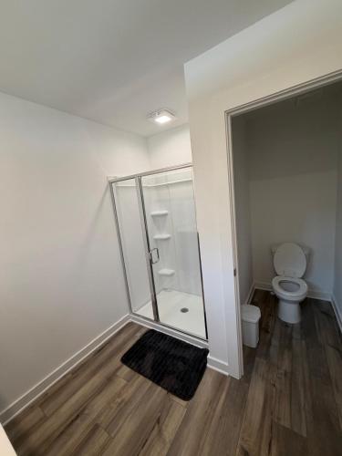 a bathroom with a toilet and a glass shower at Modern Comfort in Morrow