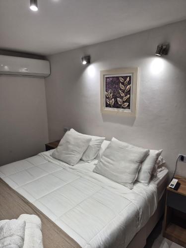 a large white bed in a room with two lights at Arena Suite LR in La Rioja