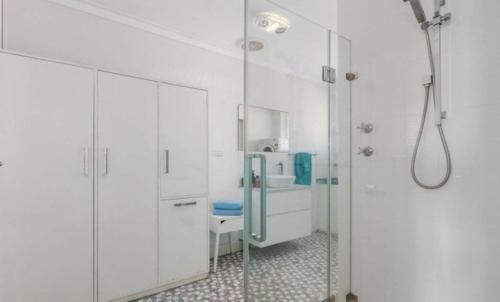 a bathroom with a glass shower and a sink at Ocean Views in Rockingham