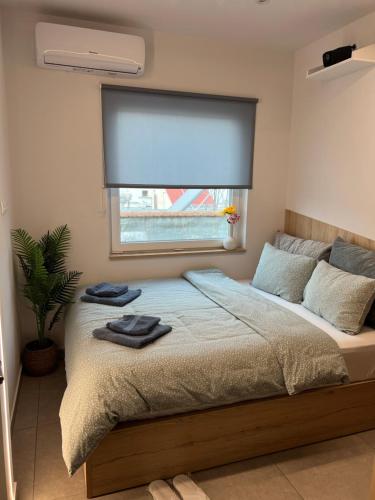 a bedroom with a large bed with a window at Madi apartment in Veria