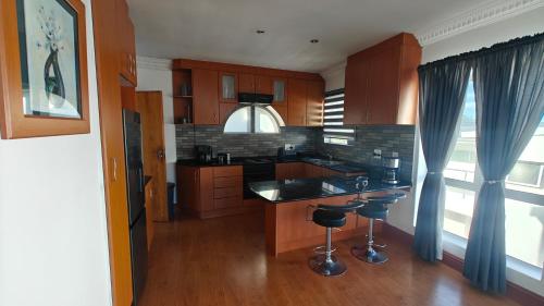 a kitchen with wooden cabinets and a counter top at Executive Sea View Apartment in Glencairn