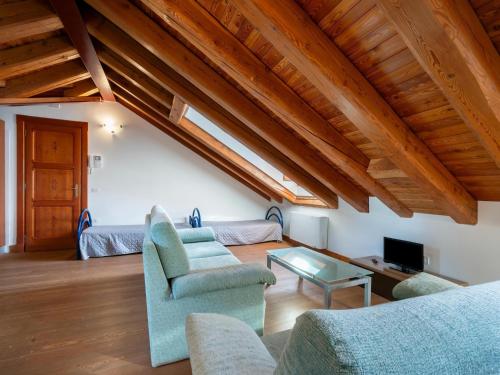 a living room with a couch and a table at Attic historic building with air conditioning in Ceresole Reale