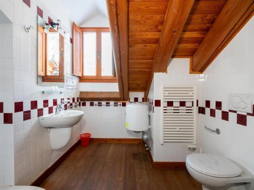 a bathroom with a toilet and a sink at Attic historic building with air conditioning in Ceresole Reale