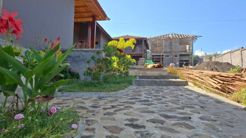 a stone walkway leading to a house at Inara Homestay in Huu