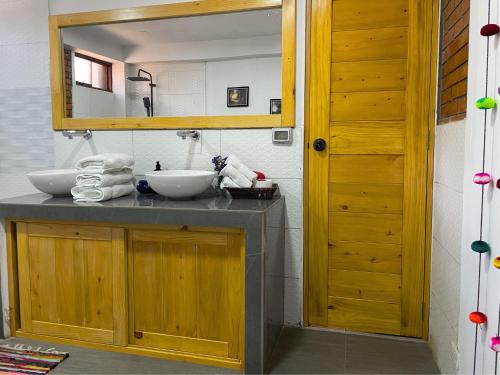 a bathroom with a sink and a mirror at Runaway Hotel in Carhuaz