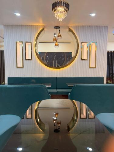 a dining room with a table and a mirror at The Highway Haven in Silchar