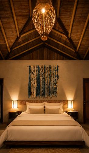 a bedroom with a large bed with a chandelier at La Cabaña de Iza in Canoas
