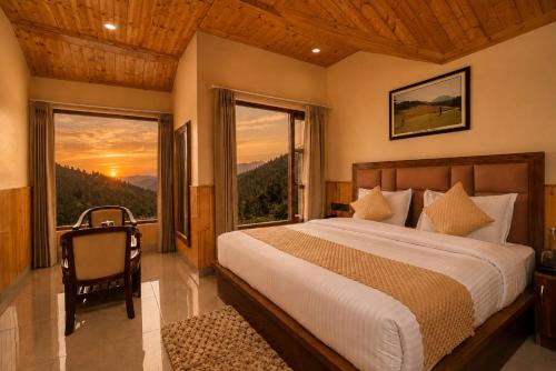 a bedroom with a bed and a large window at The Dogri Boutique Cottage, Mashobra - Luxury Cottage with Scenic mountain view in Shimla