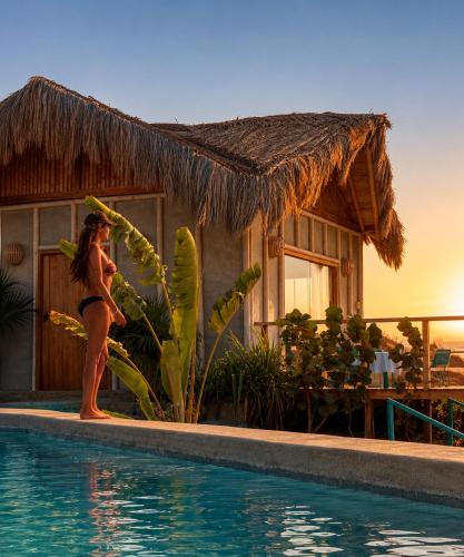 a woman in a bikini standing next to a swimming pool at La Cabaña de Iza in Canoas