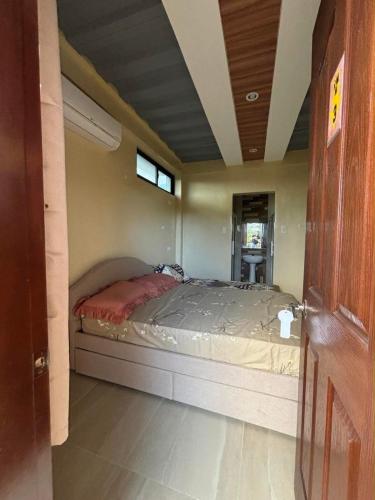 a bedroom with a bed in a room at W Island Backpackers Inn in Dauis