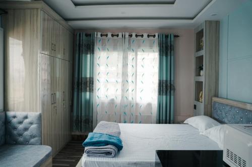 a bedroom with two beds and a window at Kathmandu Mountain view Studio in Bālāju