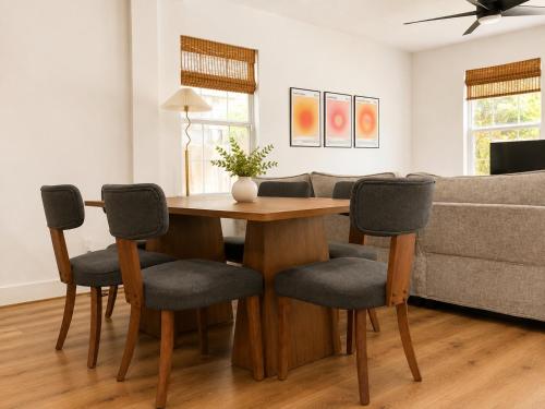 a living room with a wooden table and chairs at Houston House - Free Parking in Houston