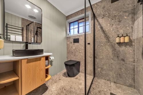 a bathroom with a shower and a sink at Plum Pines Bright in Bright