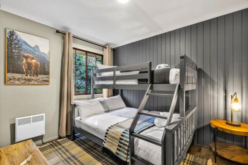 a bedroom with a bunk bed and a ladder at Plum Pines Bright in Bright