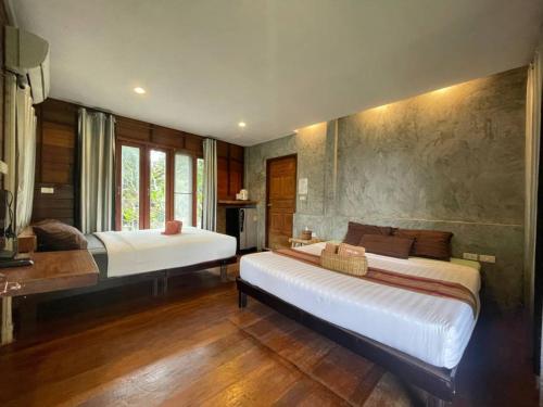 a bedroom with two beds in a room at Hallo Villa Khanom in Khanom