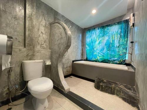 a bathroom with a toilet and a shower and a tub at Hallo Villa Khanom in Khanom