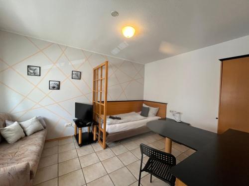 a living room with a couch and a table at Apartmenthaus Home24 in Chemnitz