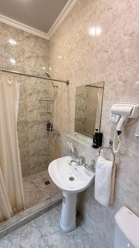 a bathroom with a sink and a shower at Art inn hotel in Tashkent