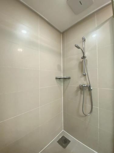 a bathroom with a shower with a glass door at Wh in HighVill in Astana