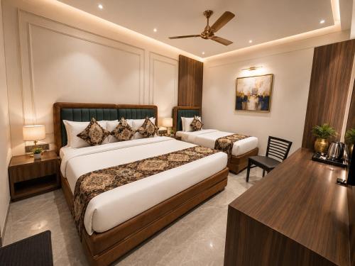 a hotel room with two beds and a table at Hotel Next View Amritsar # Pool # Parking # Family Hotel # Best choice for Tourists in Amritsar