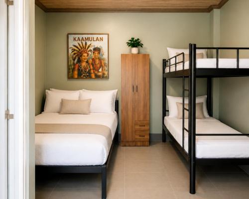 two bunk beds in a room with two bunk beds at Casa Amul in Tigbawan