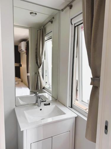 a bathroom with a sink and a mirror at Chrissa Camping Rooms & Bungalows in Delphi