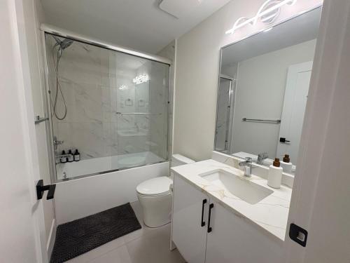 a bathroom with a sink and a shower and a toilet at Guest Suite in Mission in Mission
